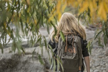 Woman Wearing Black Elbow-sleeved Shirt and Backpack