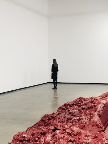 Woman Wearing Black Elbow-sleeved Top Standing on Gray Concrete Floor