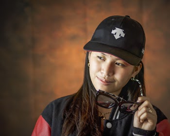 Woman Wearing Black Fitted Cap Holding Clear Eyeglasses With Black Frame