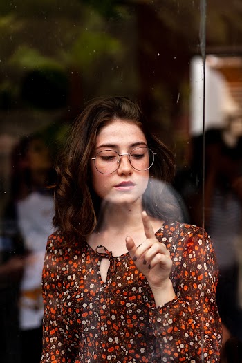 Woman Wearing Black Framed Eyeglasses Touching Glass