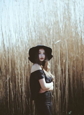 woman wearing black hat and dress