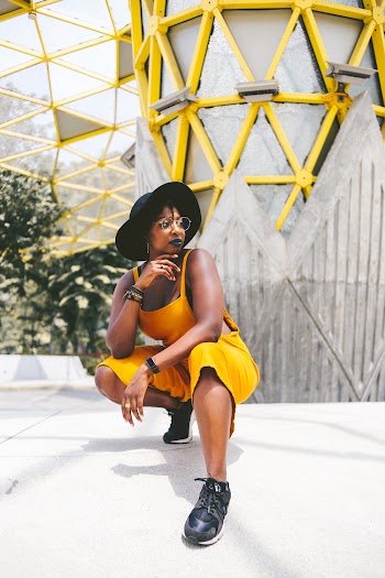 Woman Wearing Black Hat and Yellow Jumpsuit