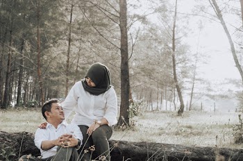 Woman Wearing Black Hijab And White Dress Shirt Sitting On Tree Log