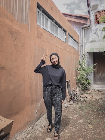 Woman Wearing Black Hijab Doing Peace Sign