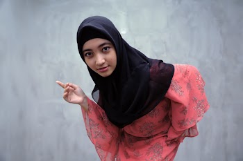 Woman Wearing Black Hijab Headscarf Standing Near Gray Wall