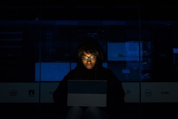 Woman Wearing Black Hoodie Jacket Holding Grey Laptop Computer