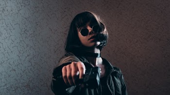 Woman Wearing Black Jacket Holding Gun