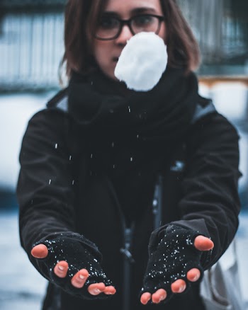 Woman Wearing Black Jacket Holding White Snow
