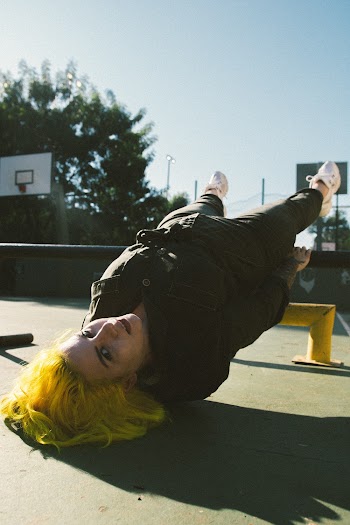 Woman Wearing Black Jacket Planking on Black Steel Pole