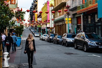 Woman Wearing Black Jacket Walking on the Road