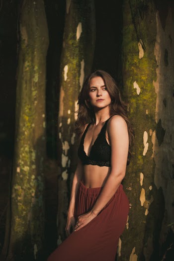 Woman Wearing Black Lace Brassiere and Red Pants