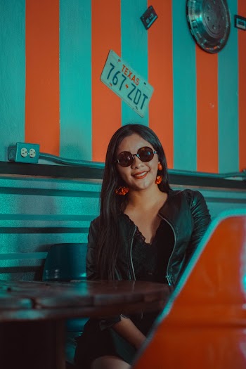 Woman Wearing Black Leather Jacket and Sunglasses