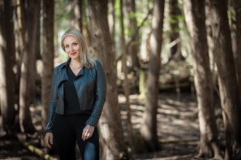Woman Wearing Black Leather Jacket in Forest