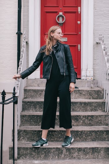 Woman Wearing Black Leather Jacket Standing on Stairs