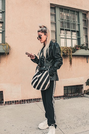 Woman Wearing Black Leather Jacket Standing on Street