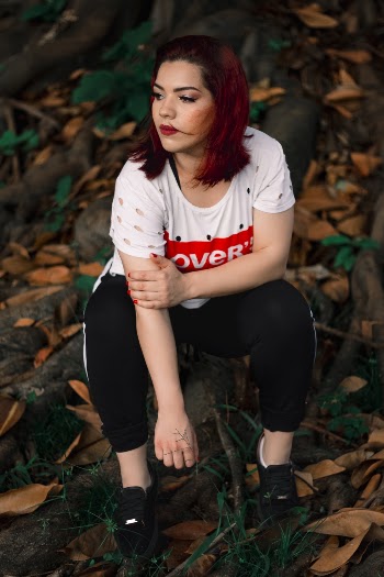 Woman Wearing Black Leggings Sitting on Gray Rock