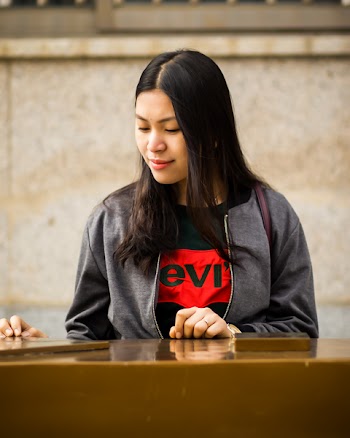 Woman Wearing Black Levis Crew-neck Shirt and Gray Zip-up Jacket