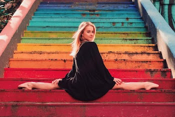Woman Wearing Black Long Sleeve Dress Sitting on Stairs