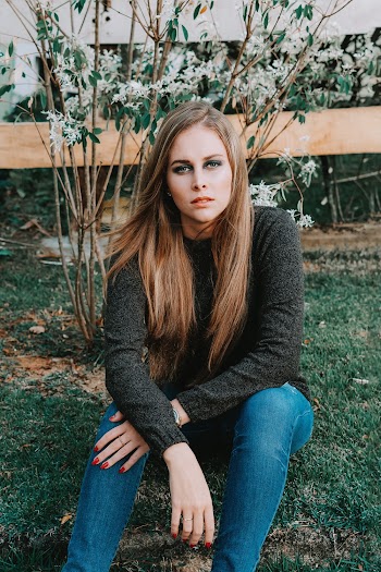 Woman Wearing Black Long Sleeve Shirt And Blue Denim Jeans