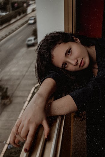 Woman Wearing Black Long Sleeve Shirt With Head On Window