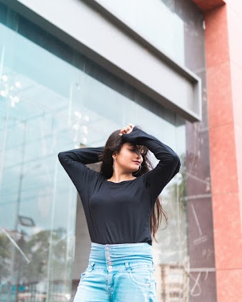 Woman Wearing Black Long-sleeved Shirt and Blue Denim Bottoms
