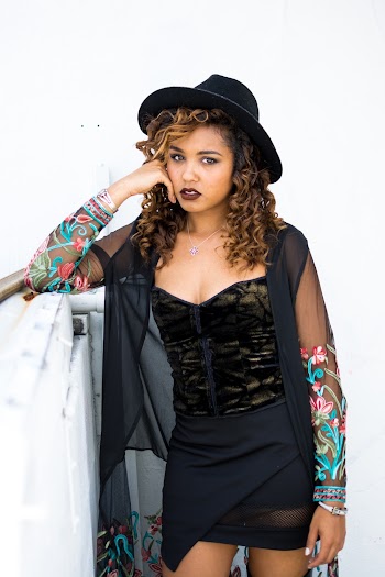 Woman Wearing Black Mini Dress and Black Hat Standing
