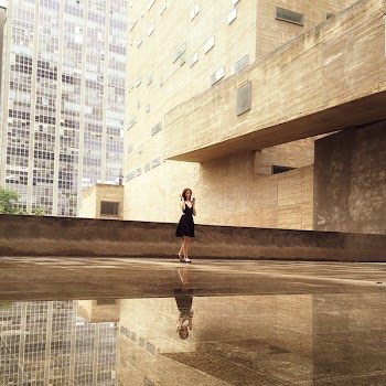 Woman Wearing Black Mini Dress Standing on the Concrete Floor