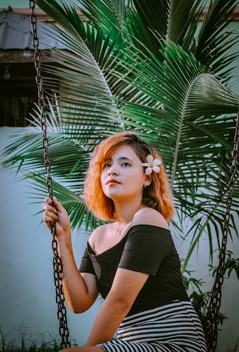 Woman Wearing Black Off-shoulder Top Sitting on Swing