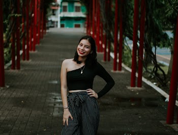 Woman Wearing Black One-shoulder Blouse and Black Pants