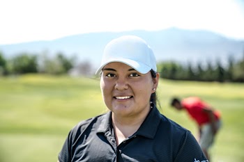 Woman Wearing Black Polo Shirt and White Cap Smiling