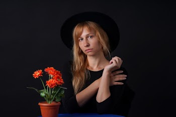 Woman Wearing Black Shirt And Black Hat 