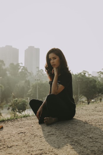 Woman Wearing Black Shirt and Pants Taking a Squat