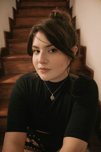 Woman Wearing Black Shirt Sitting On Staircase