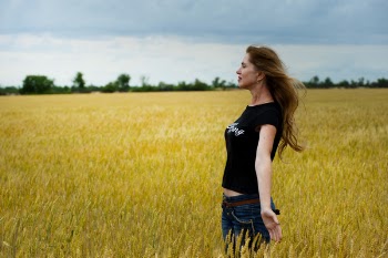 Woman Wearing Black Shirt Surrounded by Grass