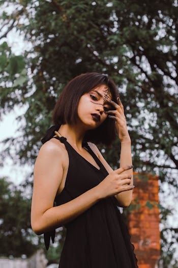 Woman Wearing Black Sleeveless Dress