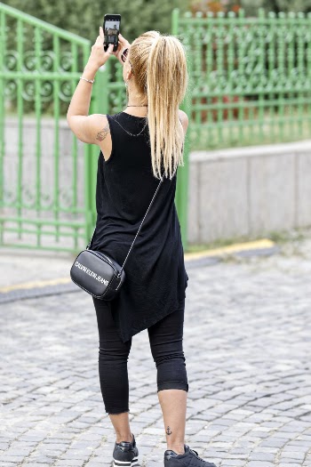 Woman Wearing Black Sleeveless Dress Holding Smartphone