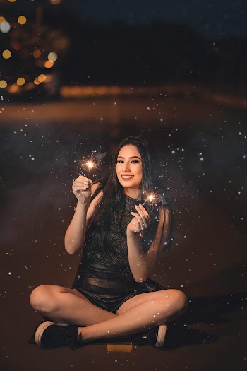 Woman Wearing Black Sleeveless Dress Holding Sparklers