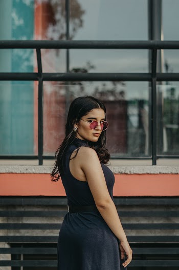 Woman Wearing Black Sleeveless Dress Standing Beside Window