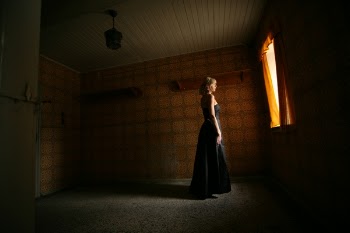 Woman Wearing Black Sleeveless Dress Standing Near Open Window