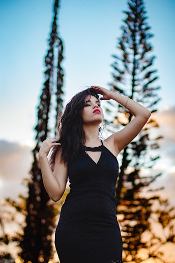 Woman Wearing Black Sleeveless Mini Dress Near Trees