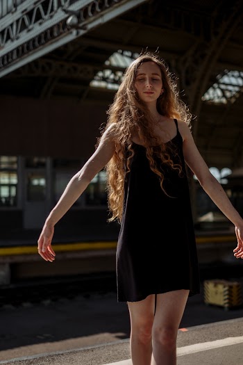 Woman Wearing Black Sleeveless Minidress