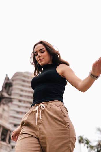Woman Wearing Black Sleeveless Shirt and Brown Pants