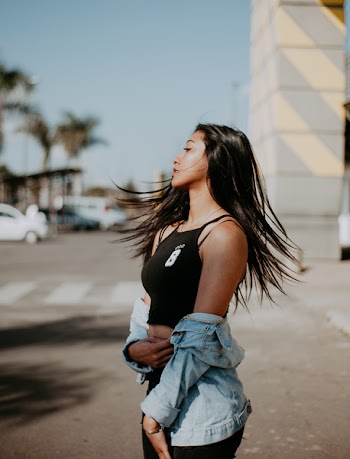 Woman Wearing Black Sleeveless Shirt Whipping Hair
