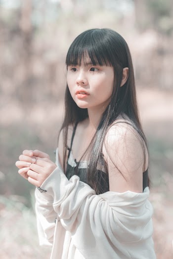 Woman Wearing Black Spaghetti Strap Top and White Sweater