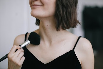 Woman Wearing Black Spaghetti Strap Top Using Makeup Brush