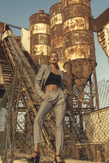 Woman Wearing Black Sports Bra And Grey Blazer Standing Near Tanks