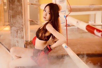 Woman Wearing Black Sports Bra and Short on Boxing Ring