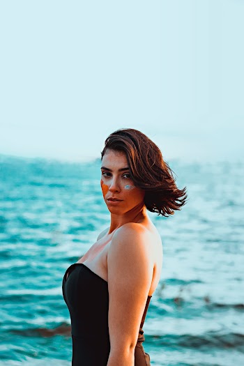 Woman Wearing Black Strapless Swimwear With Face Paint at the Beach