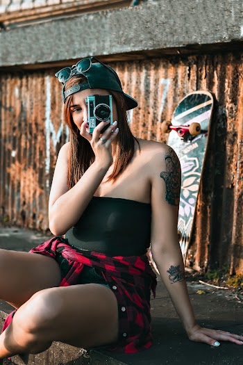 Woman Wearing Black Strapless Top Holding Gray Point-and-shoot Camera