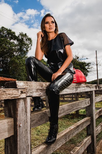 Woman Wearing Black Suit on Farm Sitting on Fence